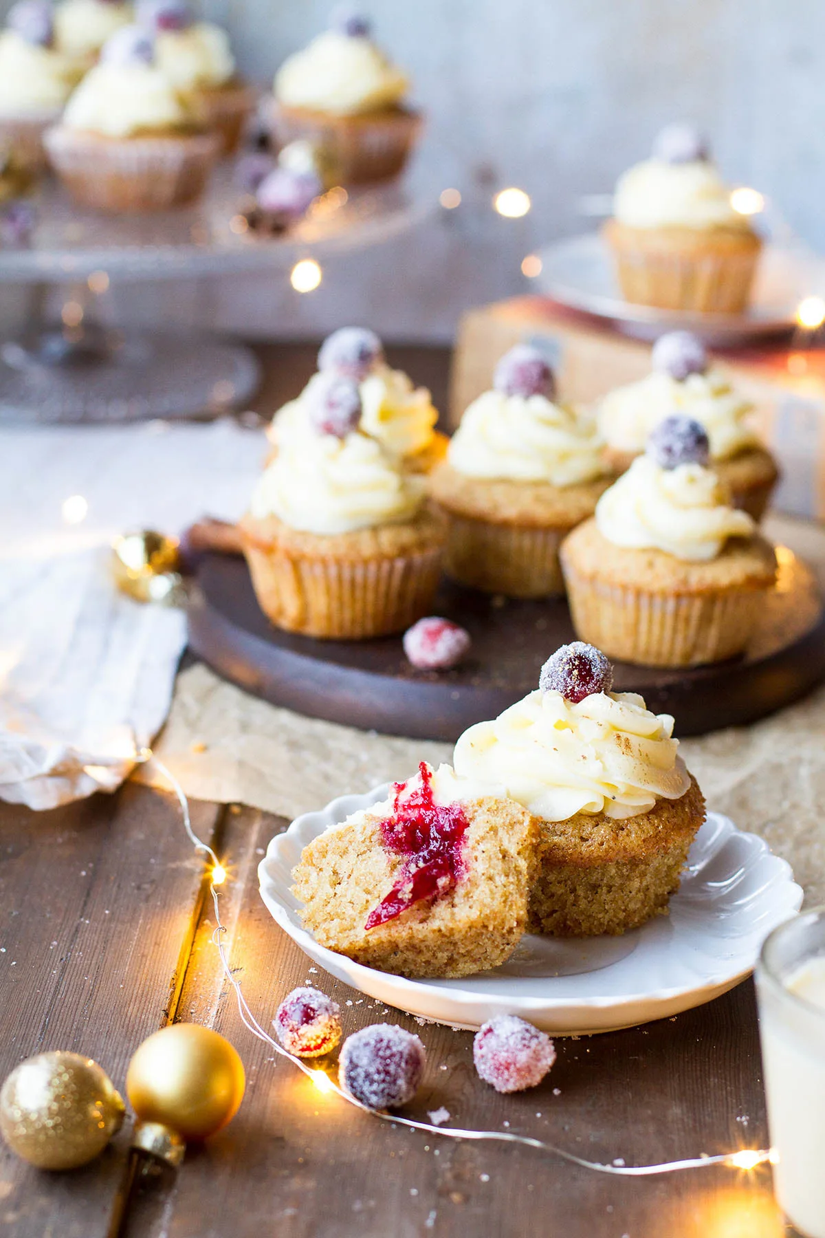 One whole and one half cupcake on a small plate, to show the cranberry sauce inside.