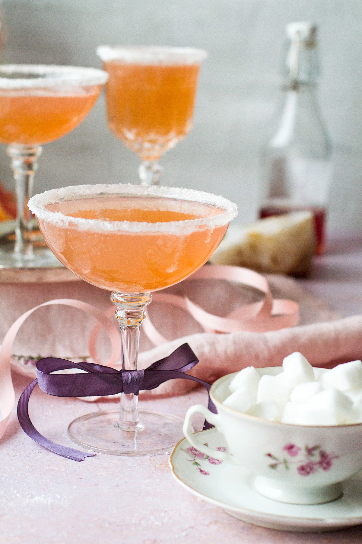 Three cocktails with a vintage pink-orange color.