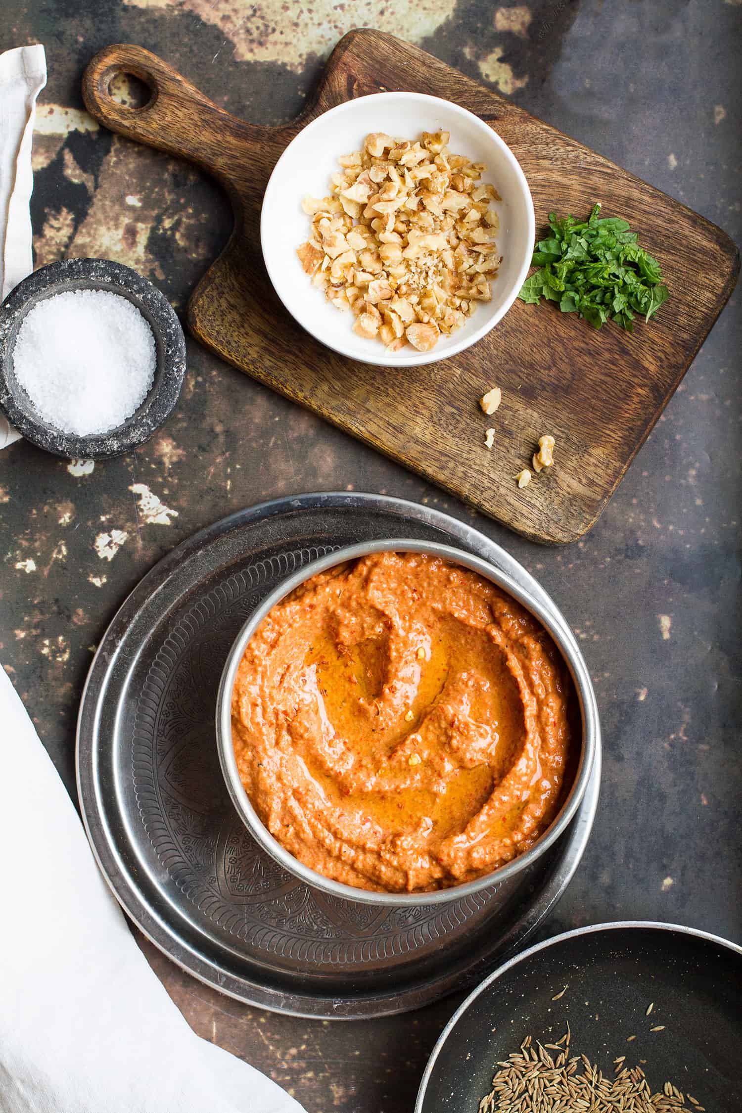 Roasted red pepper dip in a metal bowl, without toppings.