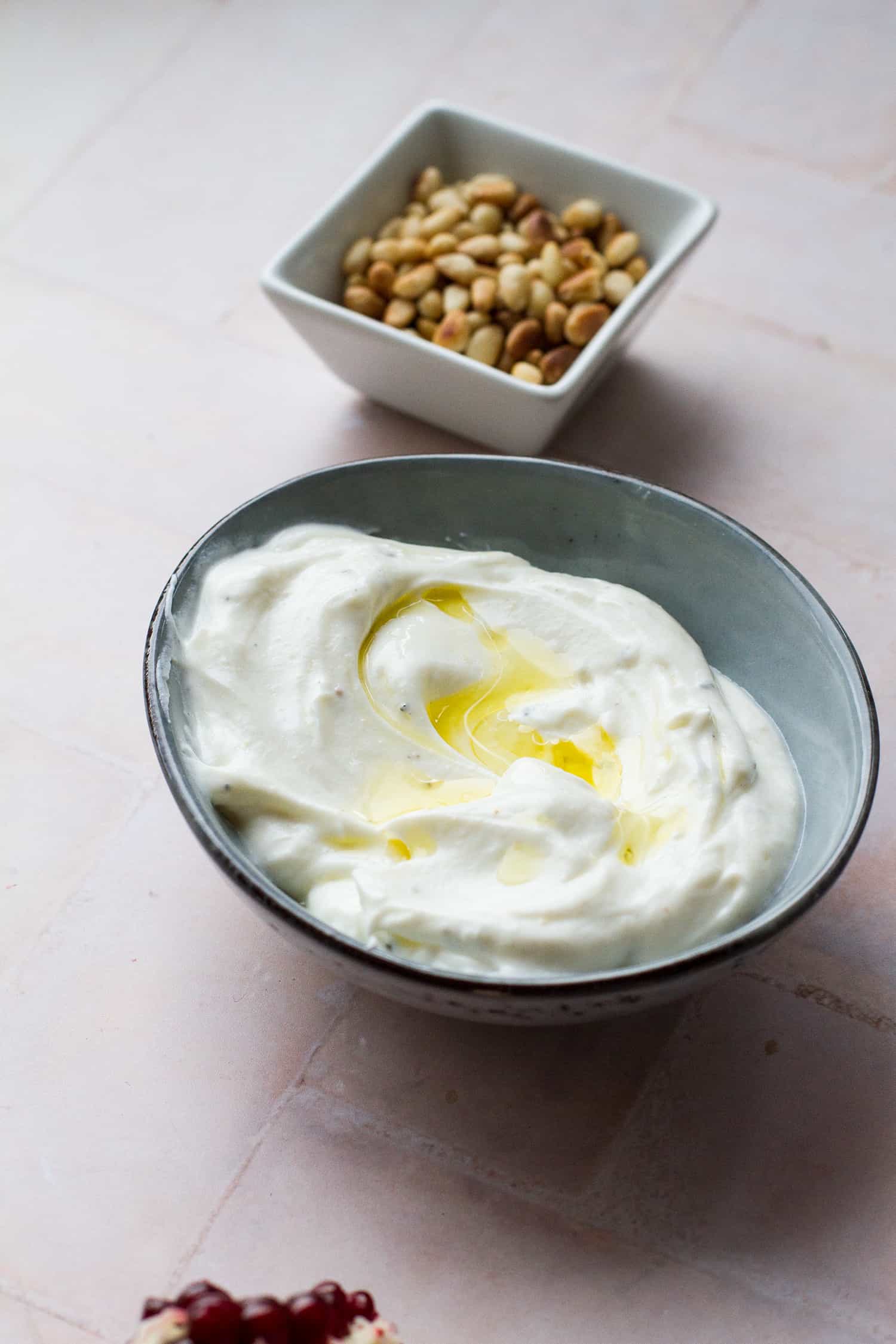 Garlic yogurt dressing in a small bowl, drizzled with olive oil.