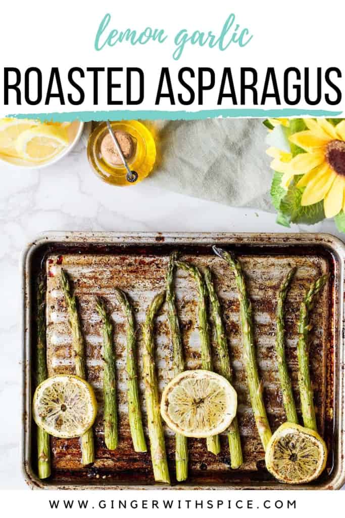 Roasted asaparagus on an old baking sheet with three lemon slices. Pinterest pin.