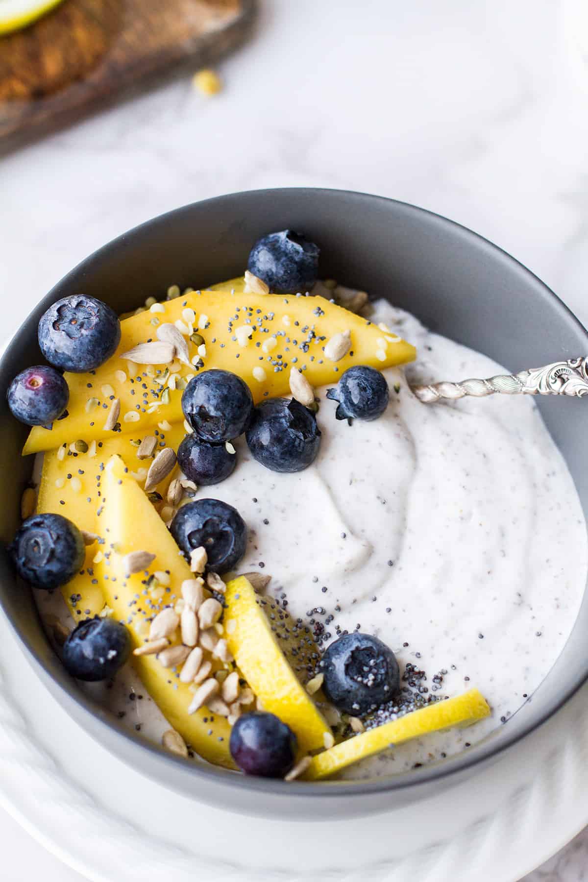 Chia pudding with mango, sunflower seeds and blueberries.