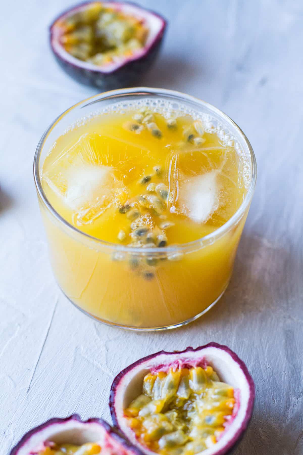 Mango passion fruit lemonade in a small bodega glass.