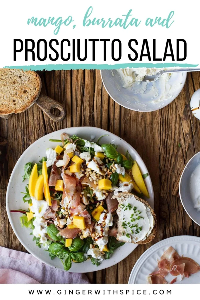 Salad on a large plate with mango, prosciutto and cream cheese. Pinterest pin.