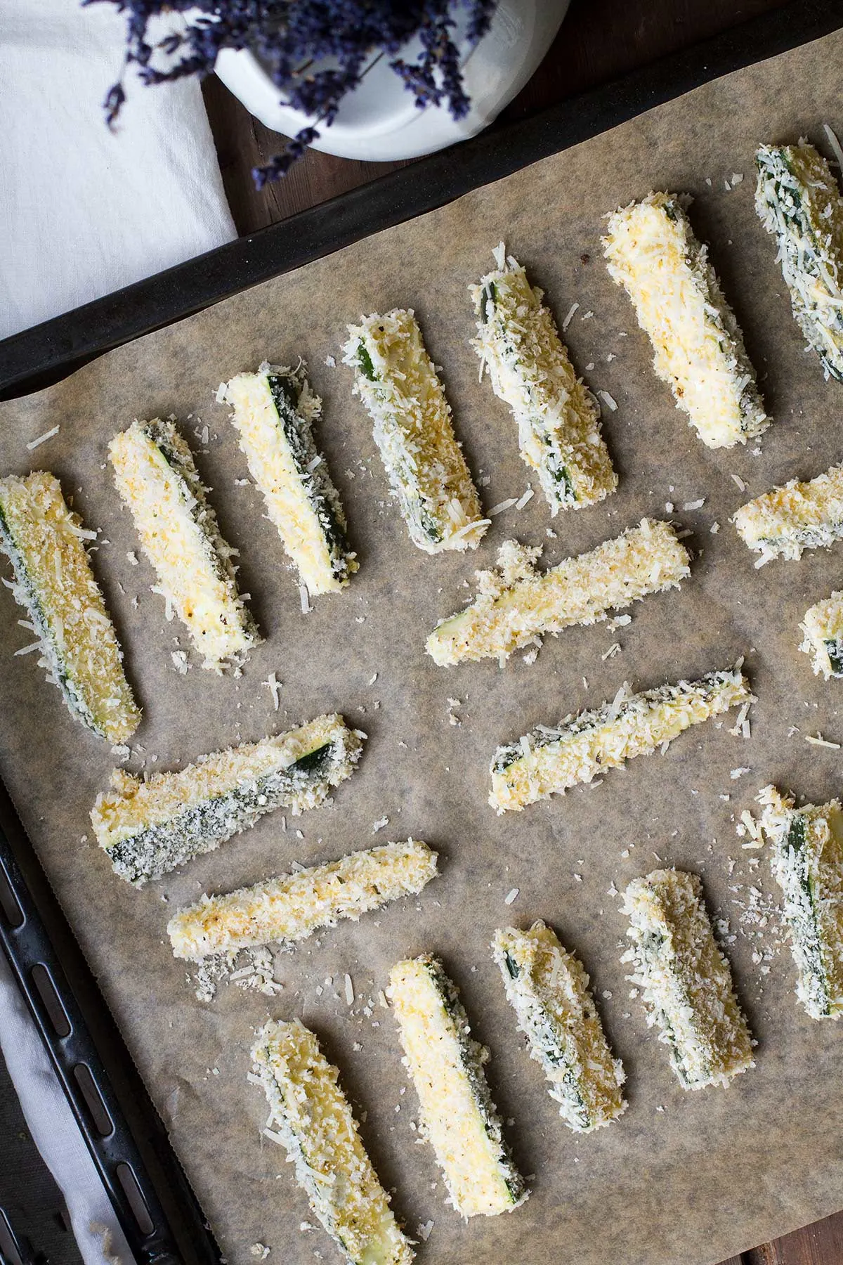 Zucchini sticks on a baking tray.