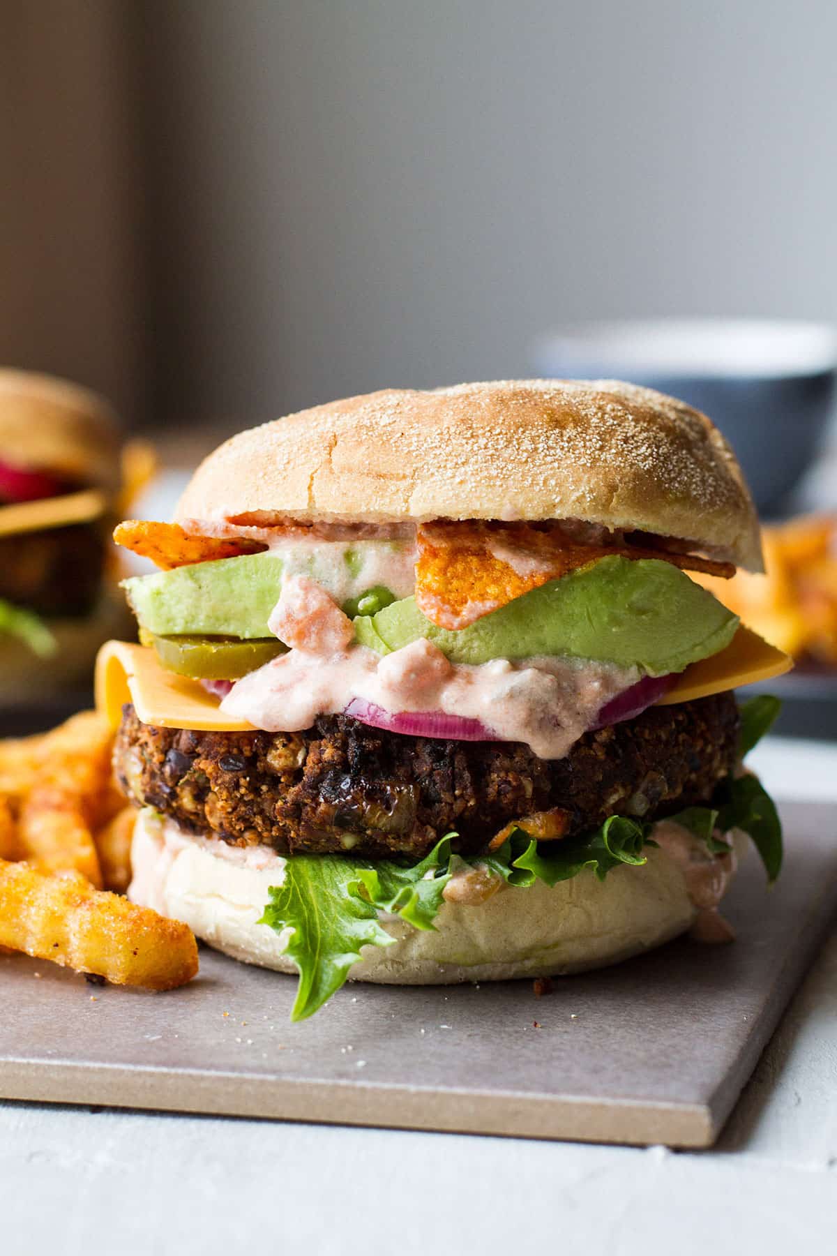 Vegetarian burger with lots of sauce and avocado.