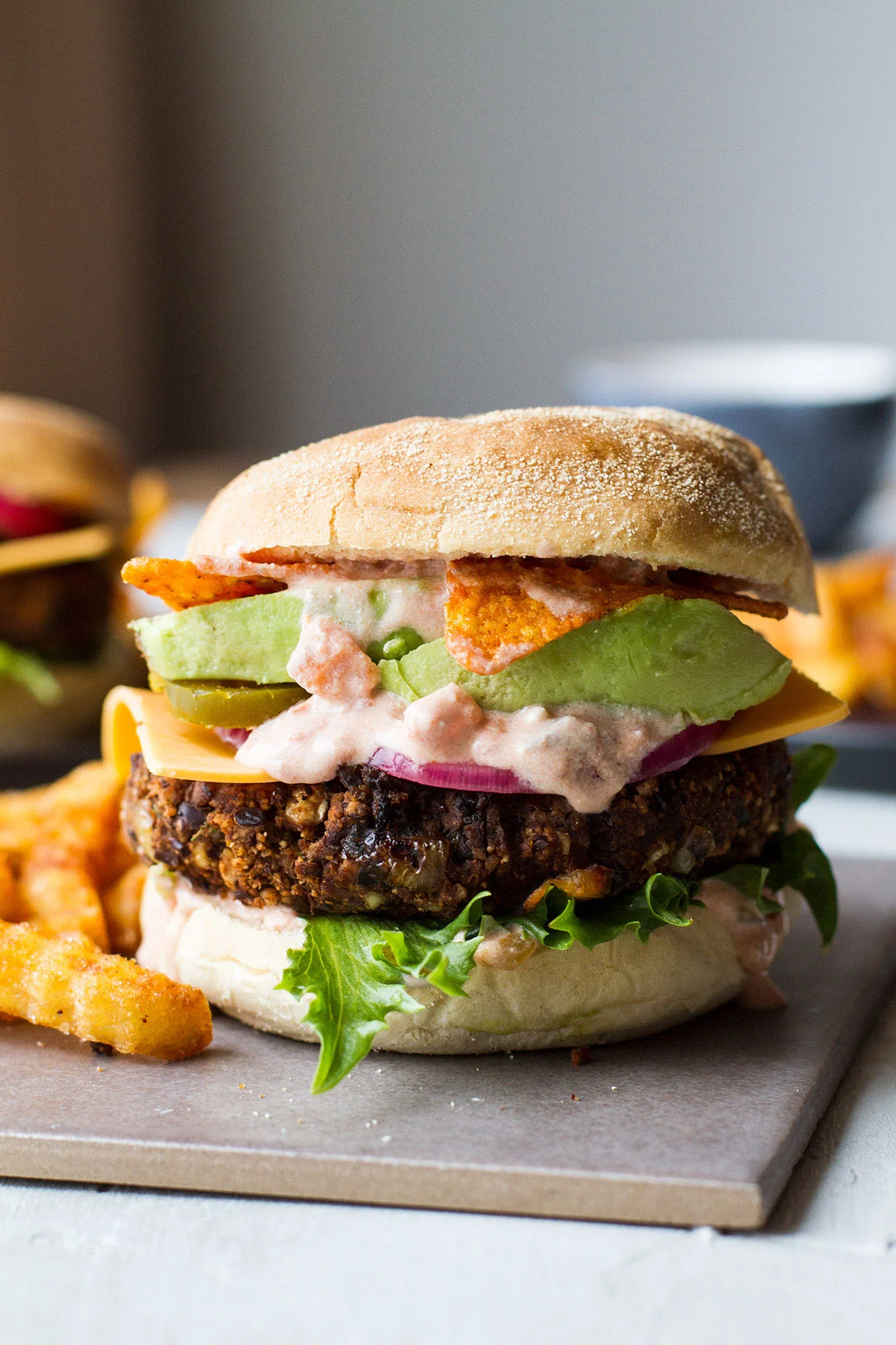 Vegetarian burger with lots of sauce and avocado.