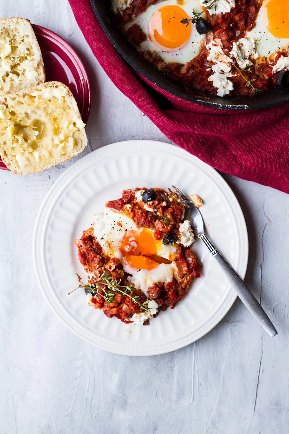 Small plate with one serving of shakshuka with chorizo.