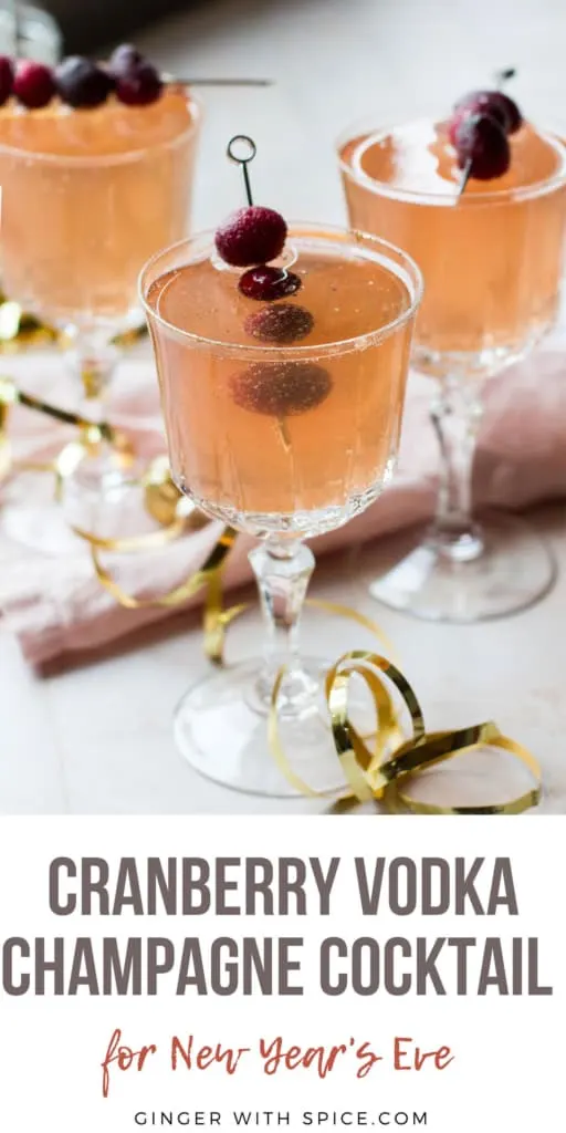 Vintage glasses with a cranberry vodka cocktail and cranberry garnish. Pinterest pin.