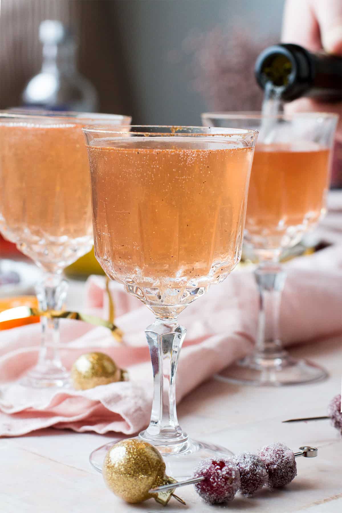 Three vintage glasses with cranberry vodka champagne.