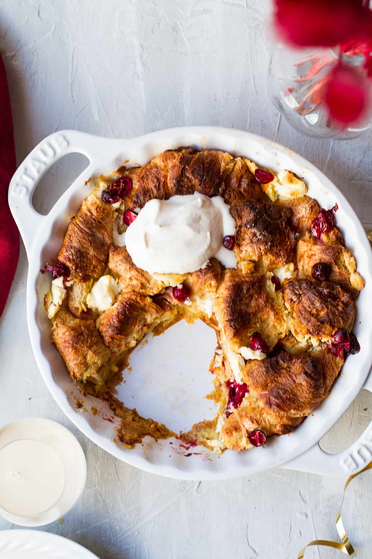 A white pie pan with eggnog french toast, one slice cut out of it.