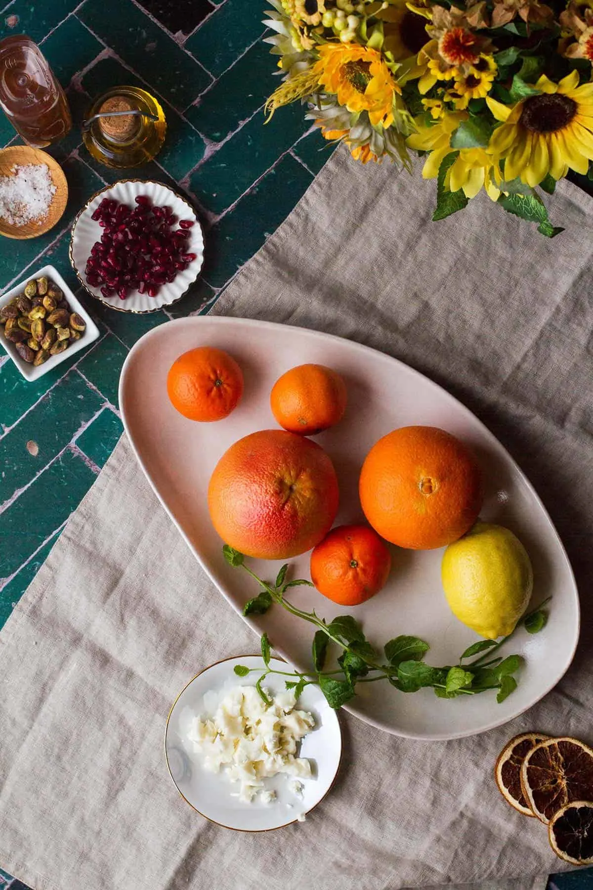 Whole citrus fruits on a rustic plate.