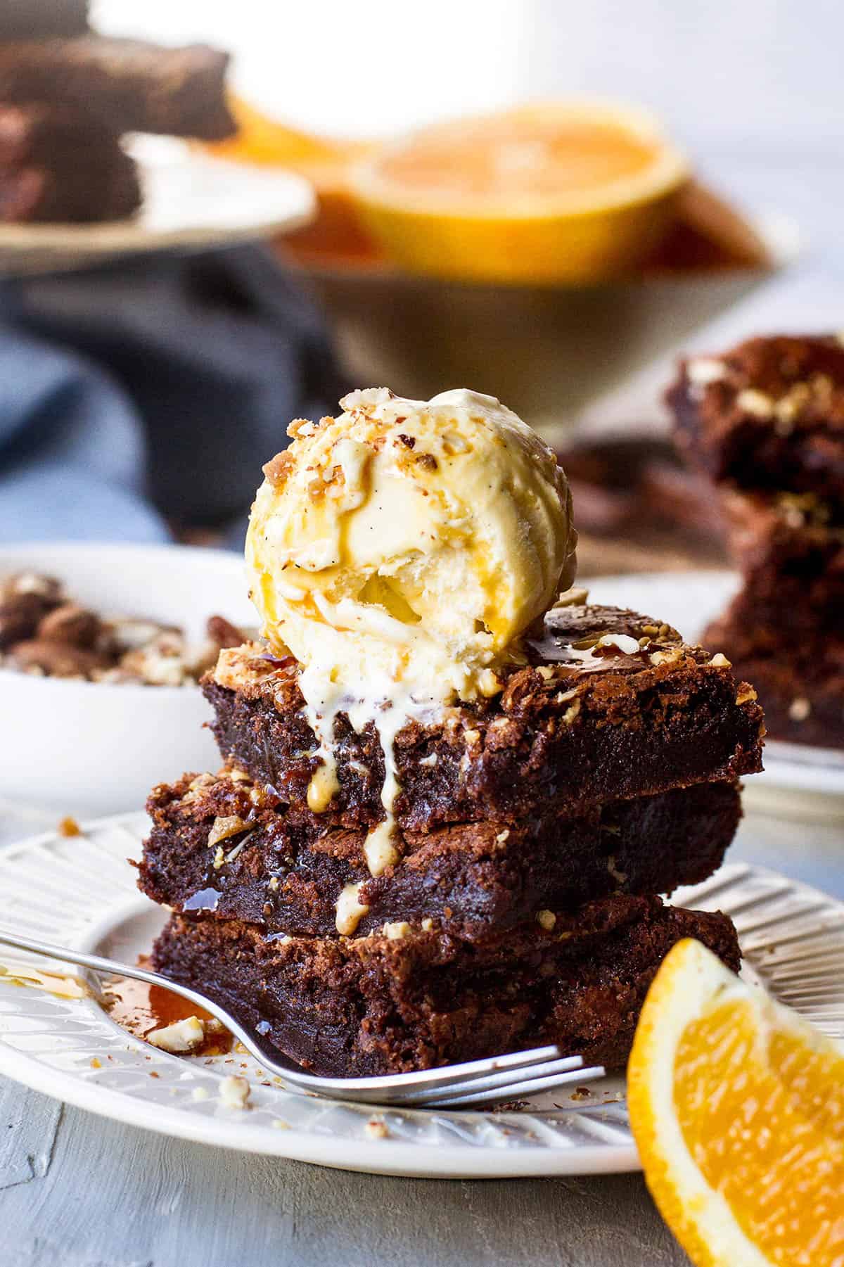 Three slices of brownies with ice cream on top.