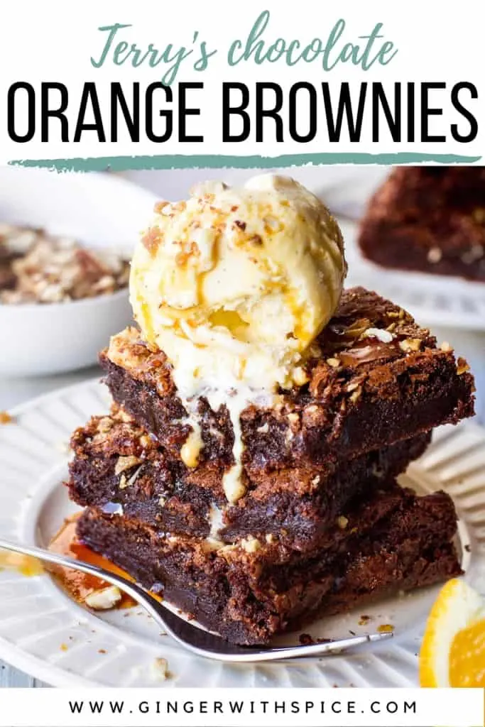 Three slices of stacked orange brownies with ice cream and almond crunch, text overlay at the top. Pinterest pin.