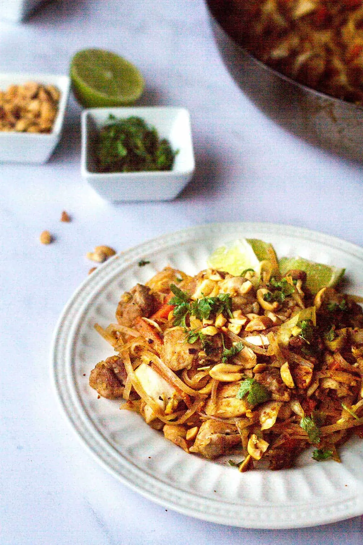 Close-up of a plate of chicken and cabbage pad thai.