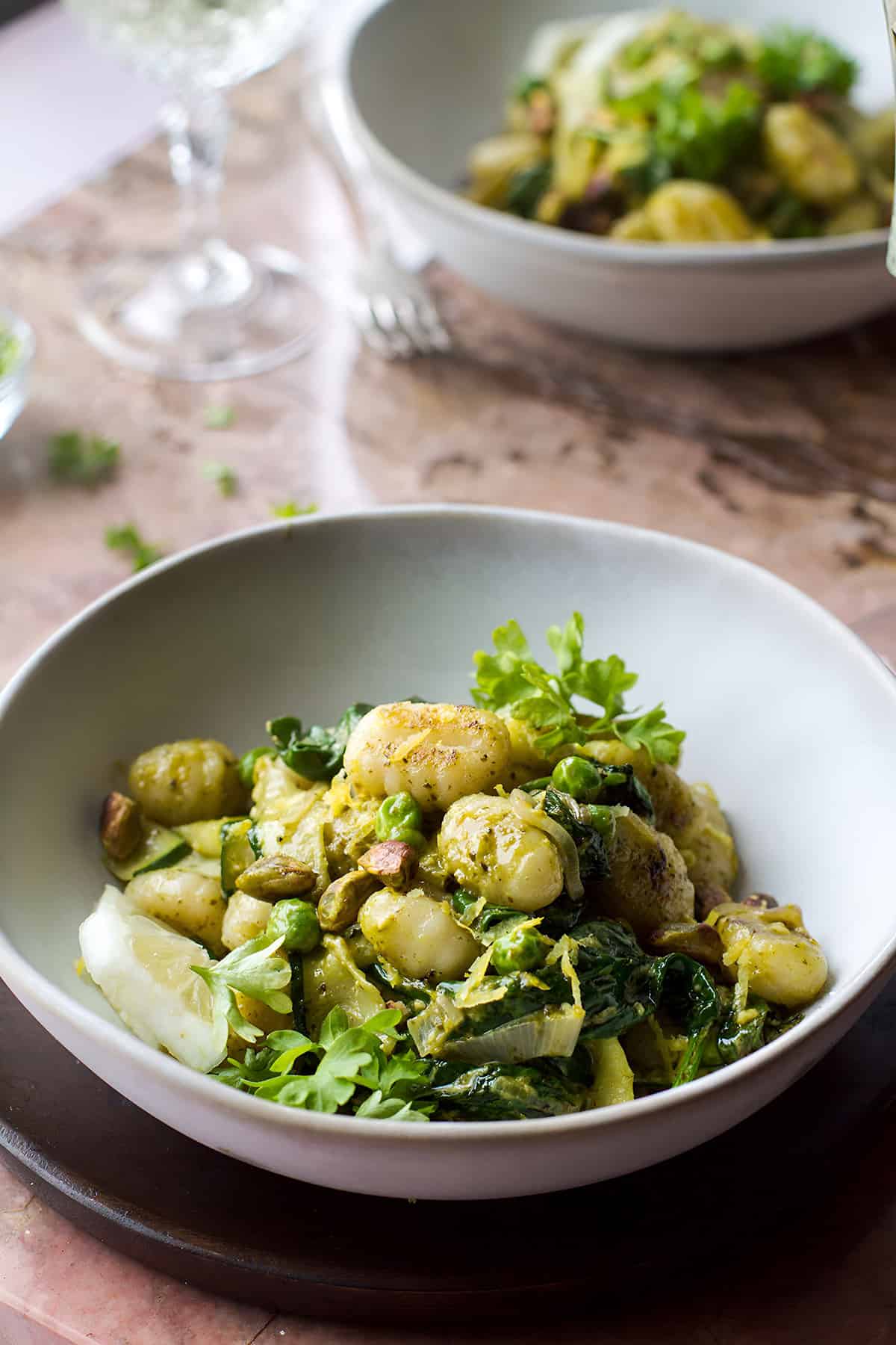 Close-up of a bowl of creamy gnocchi with zucchini.