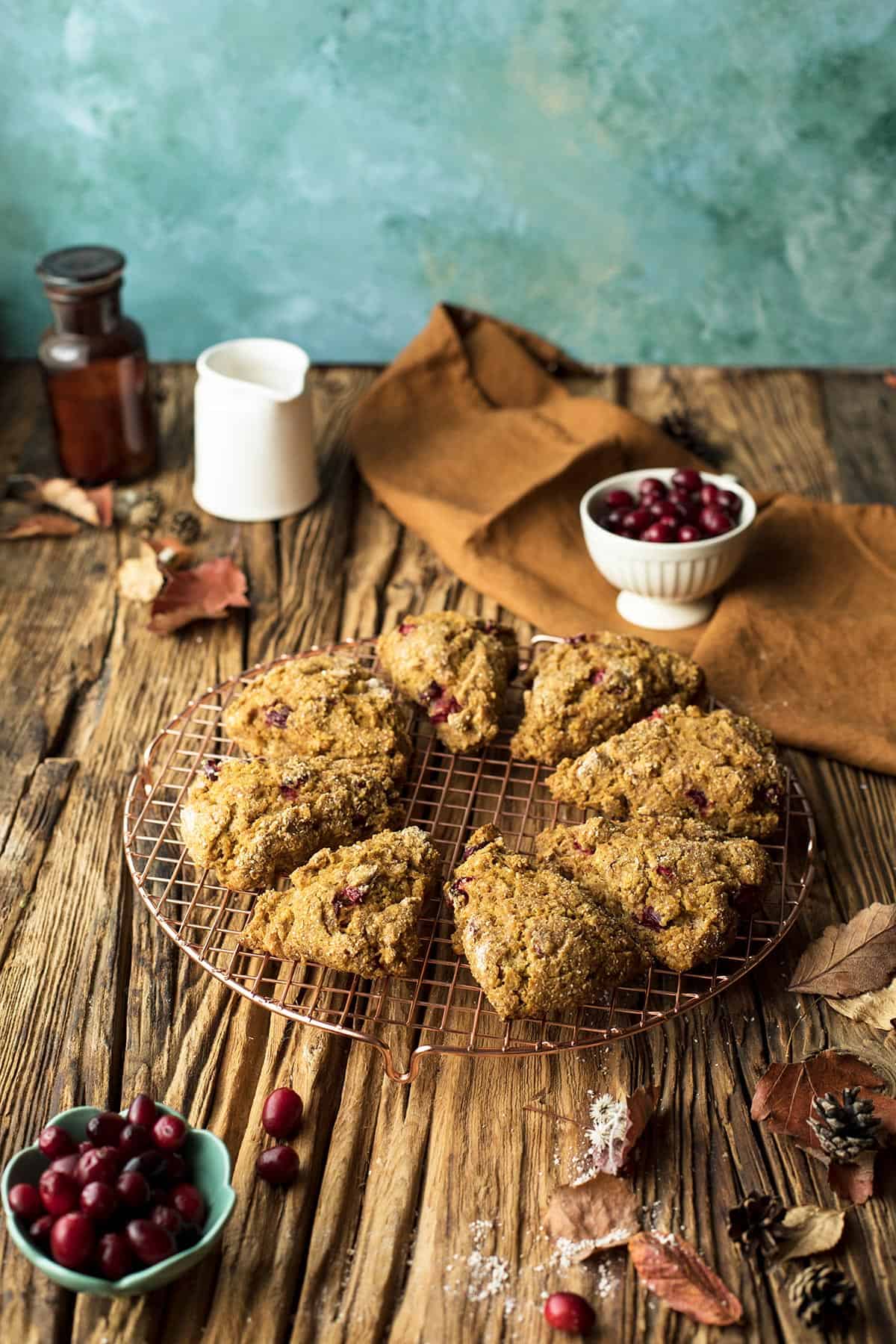 Healthy pumpkin scones on a wire rack. Wooden, rustic table.