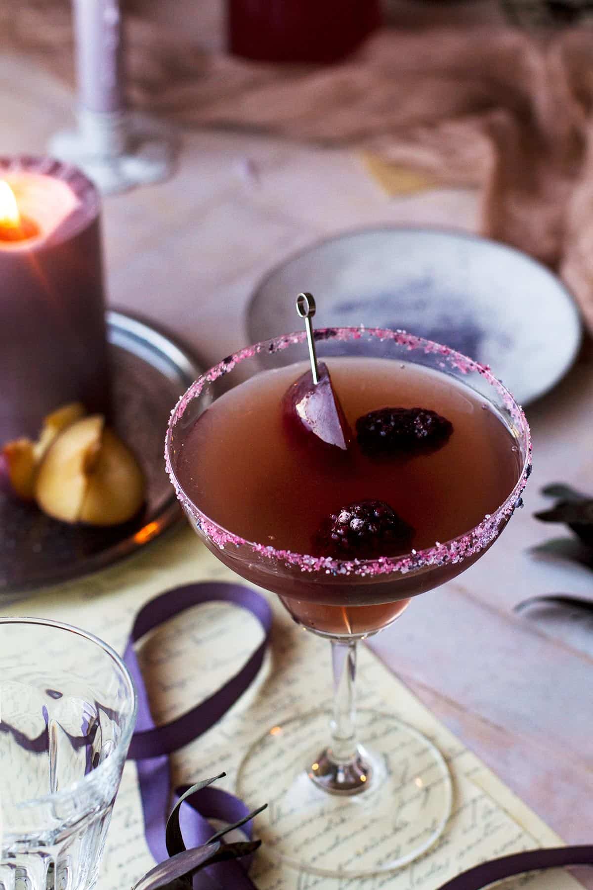 Plum cocktail in a margarita glass.