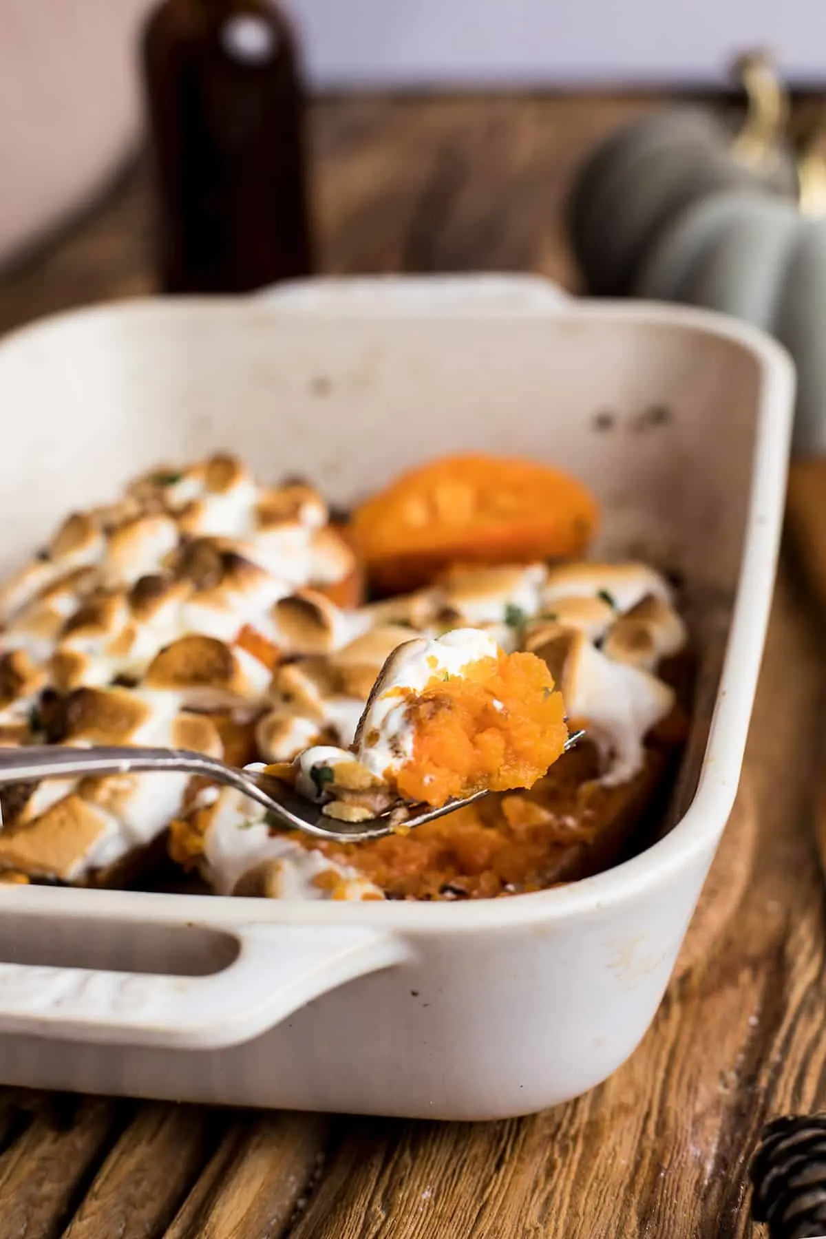 Fork with a bite of fluffy sweet potato and roasted marshmallows.