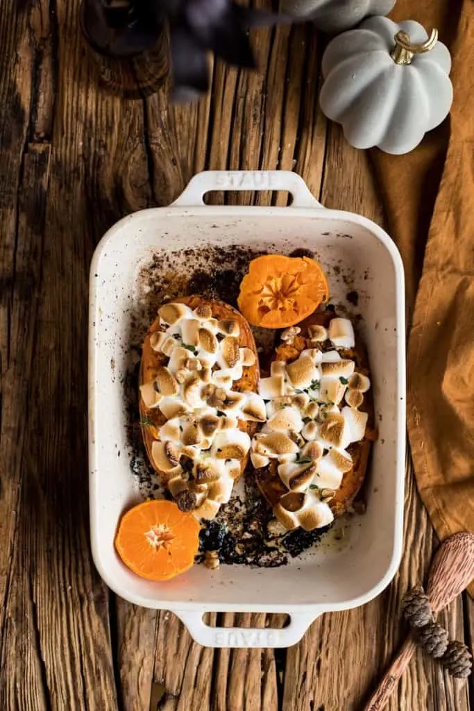 White casserole with sweet potato boats and marshmallows.