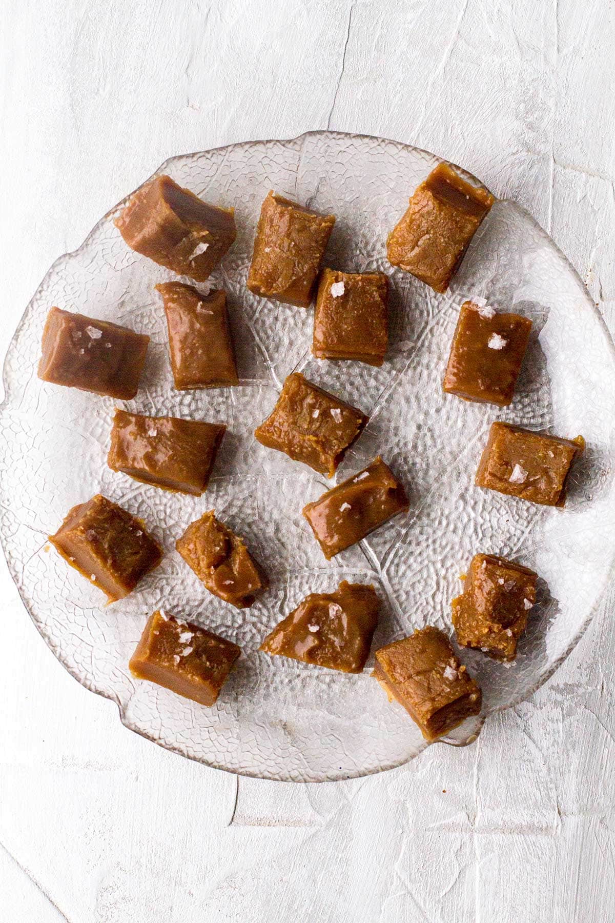 A glass plate with homemade salted caramels.