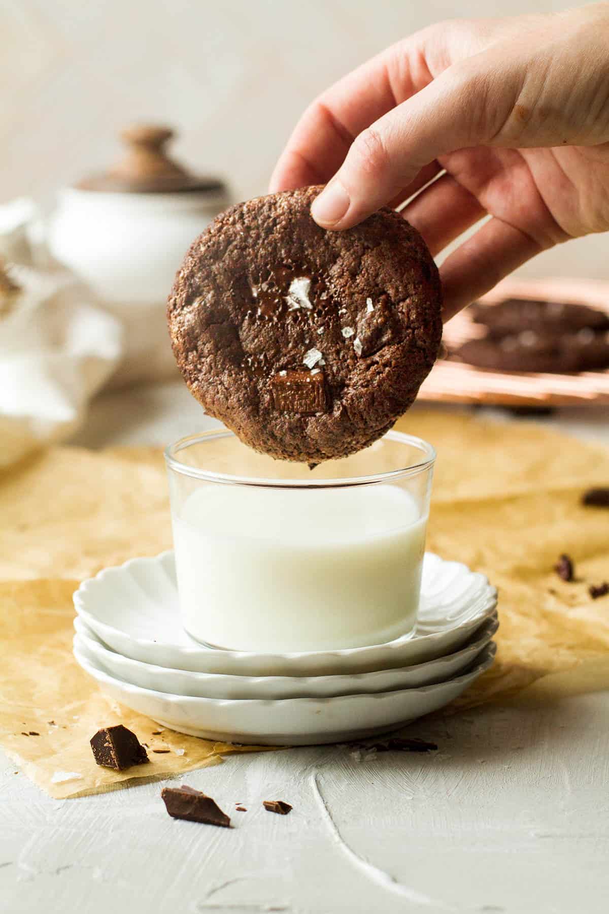 Dipping chocolate caramel cookies in a glass of milk.