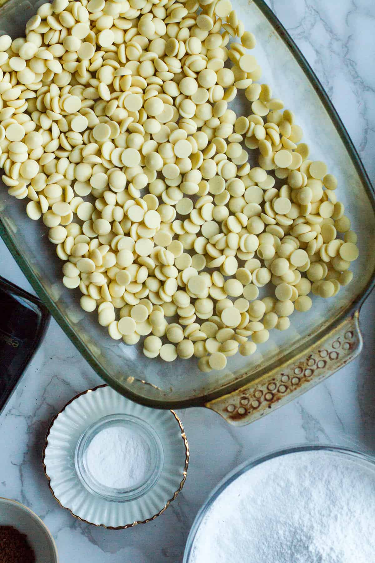 White chocolate chips in a glass pan.
