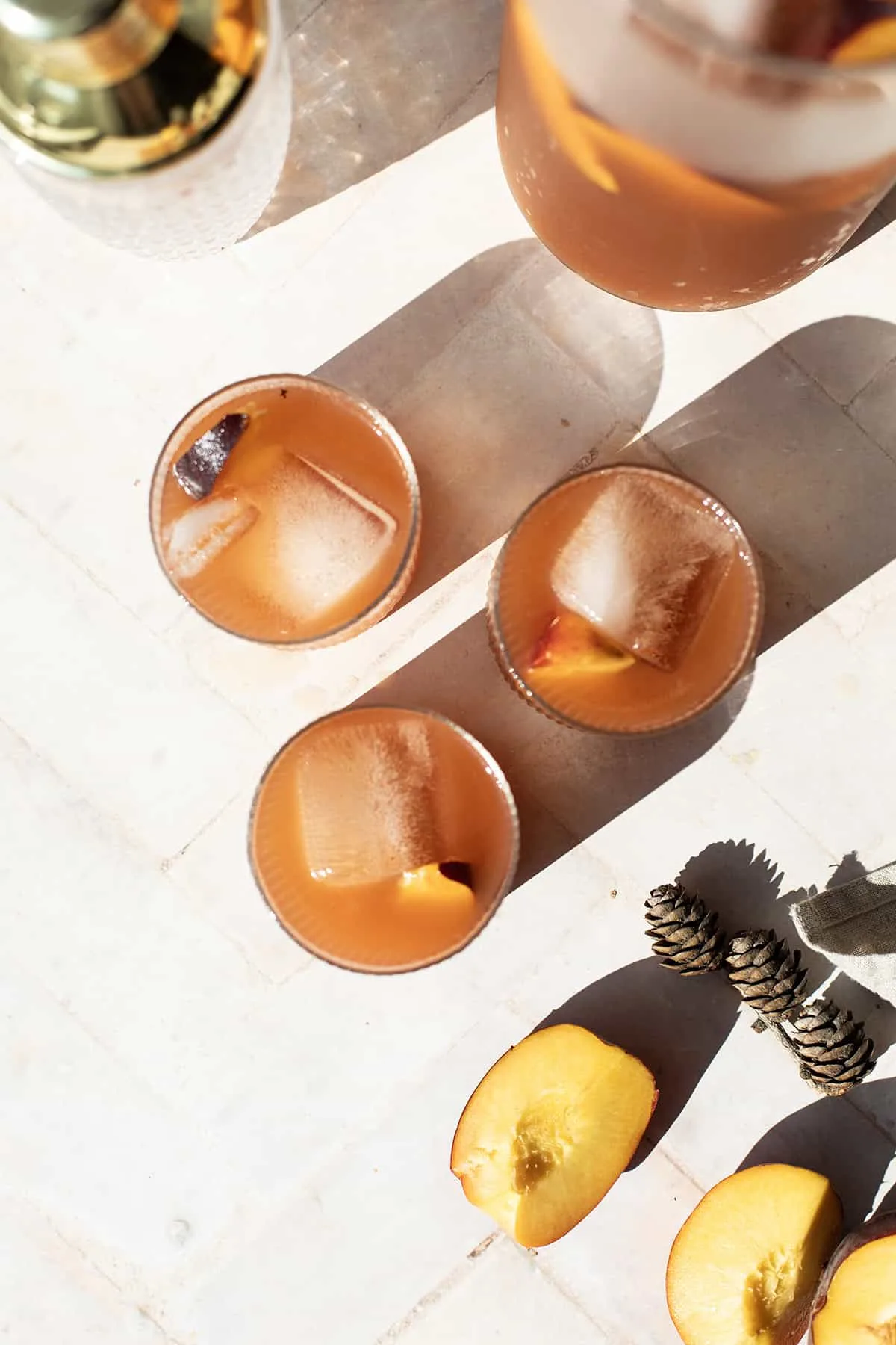 Three glasses with ice and peach tea bourbon.