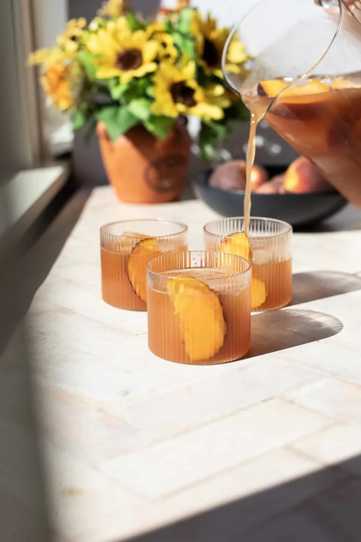 Pouring the cocktail into cocktail glasses.