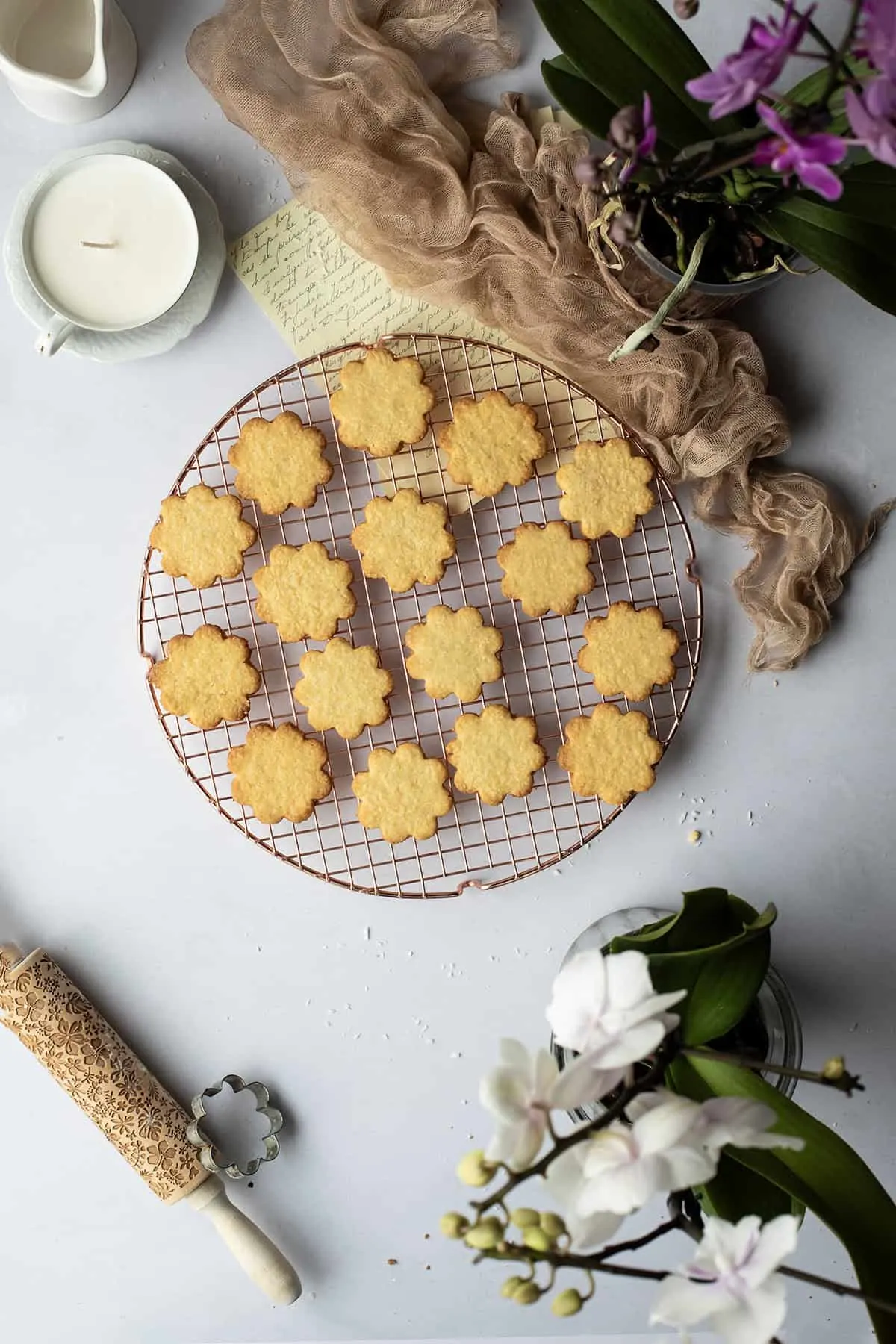 Coconut shortbread cookies on a round cooling rack.