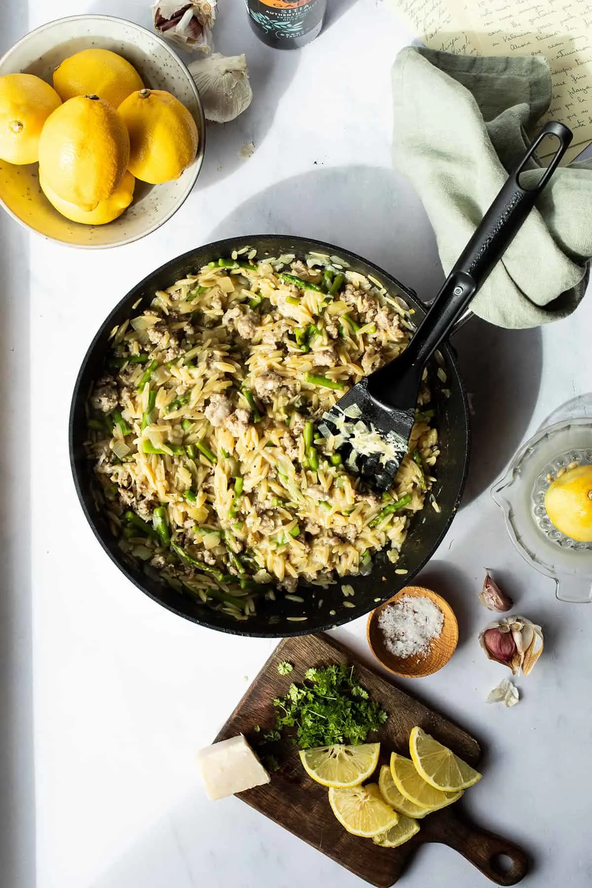 Skillet seen from above with lemon parmesan sausage orzo.