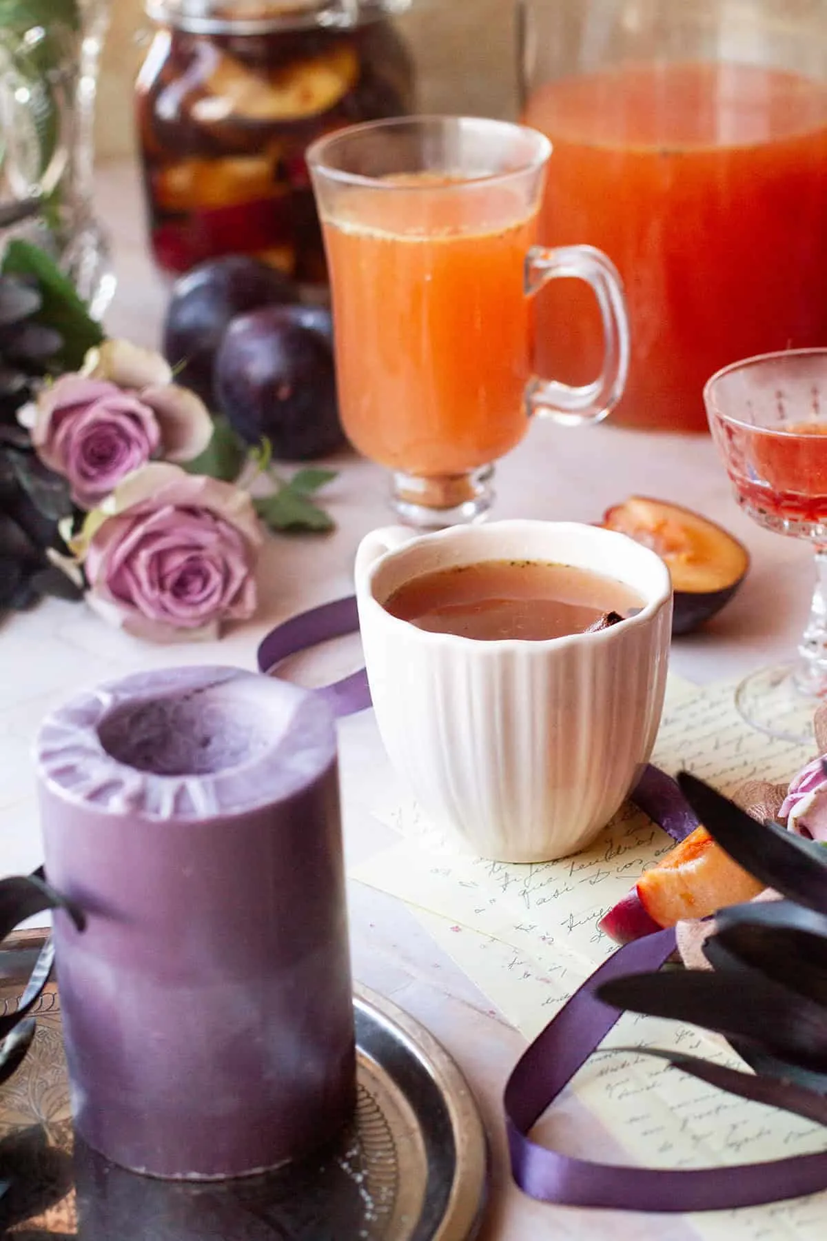 A pink cup with spiced plum cider.