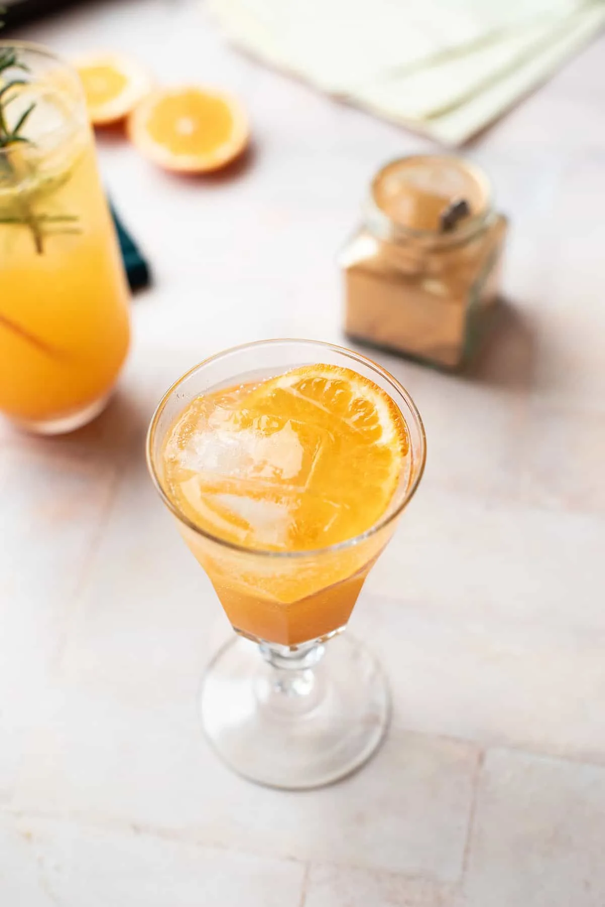 An old vintage glass with a mandarin drink and a slice of tangerine.