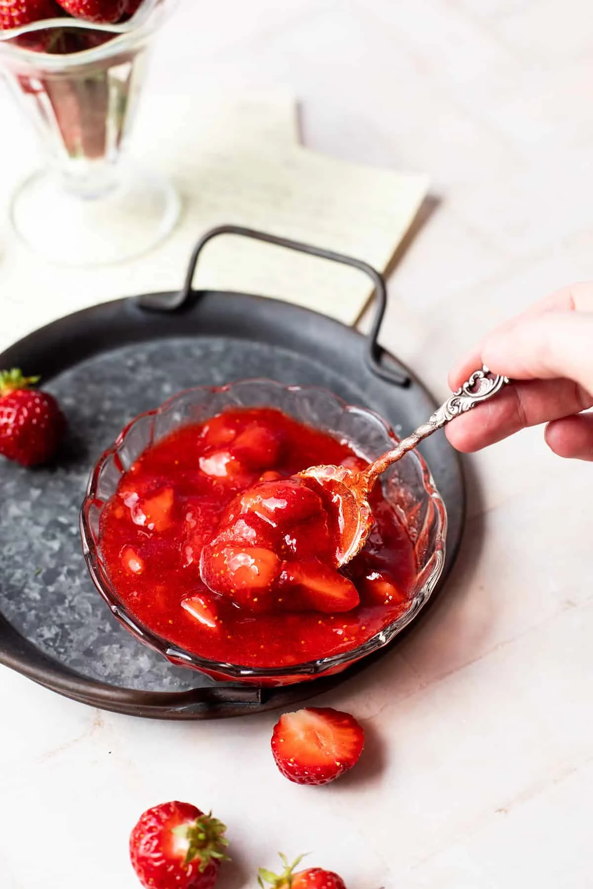 Taking a spoonful of strawberry jam.
