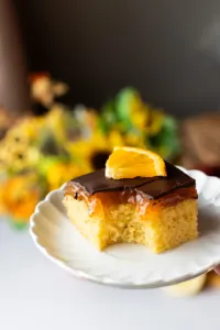 Taken a bite out of a orange cake with jelly layer.