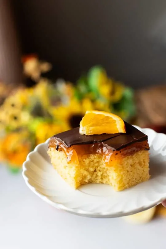 Taken a bite out of a orange cake with jelly layer.