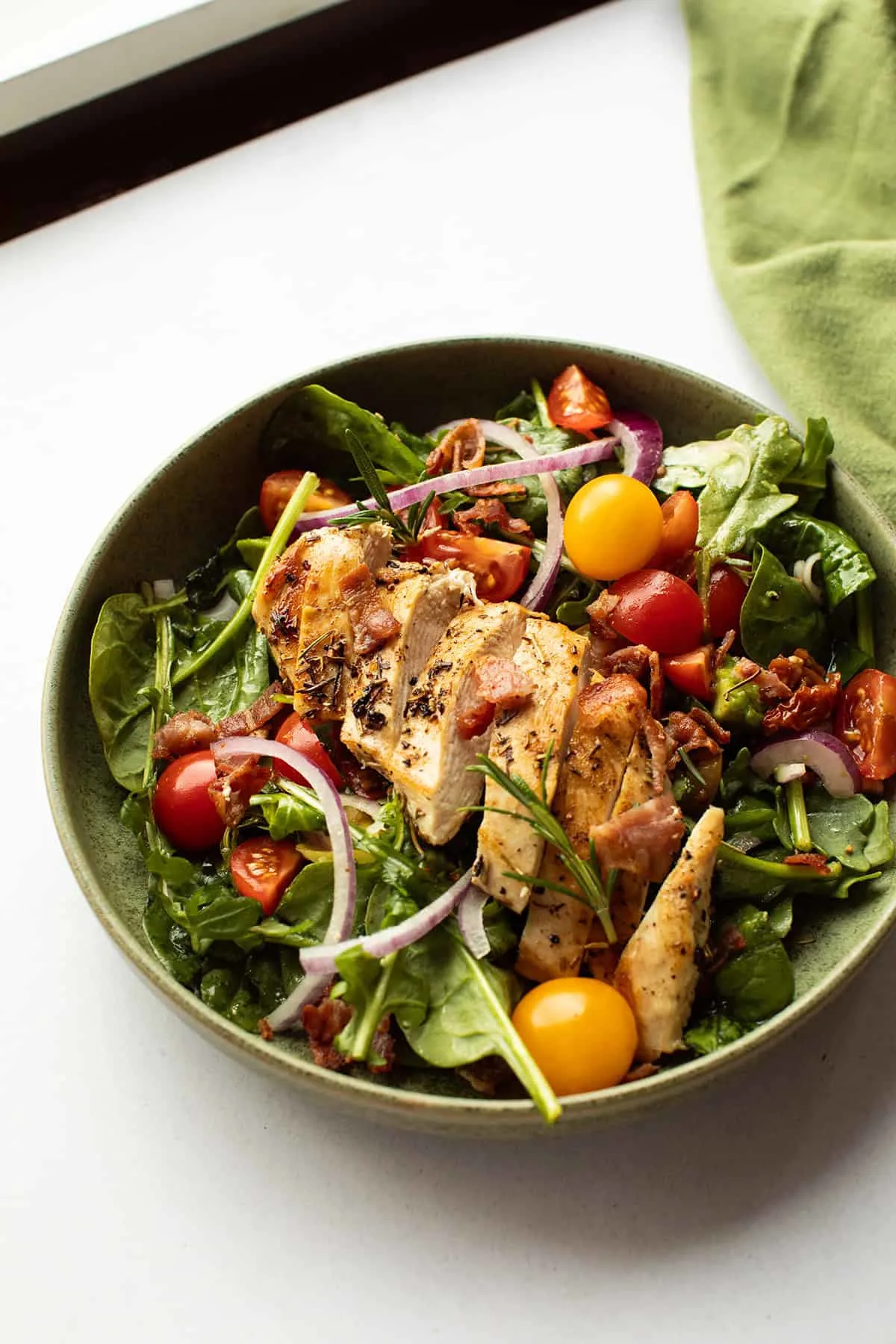 Green bowl with chicken salad.