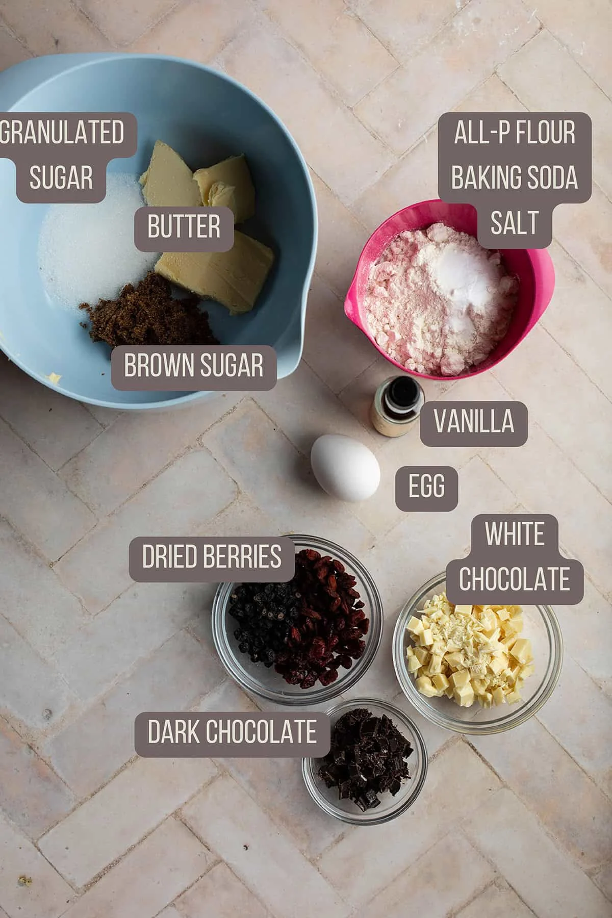 Ingredients to make chocolate chip cookies with dried berries.