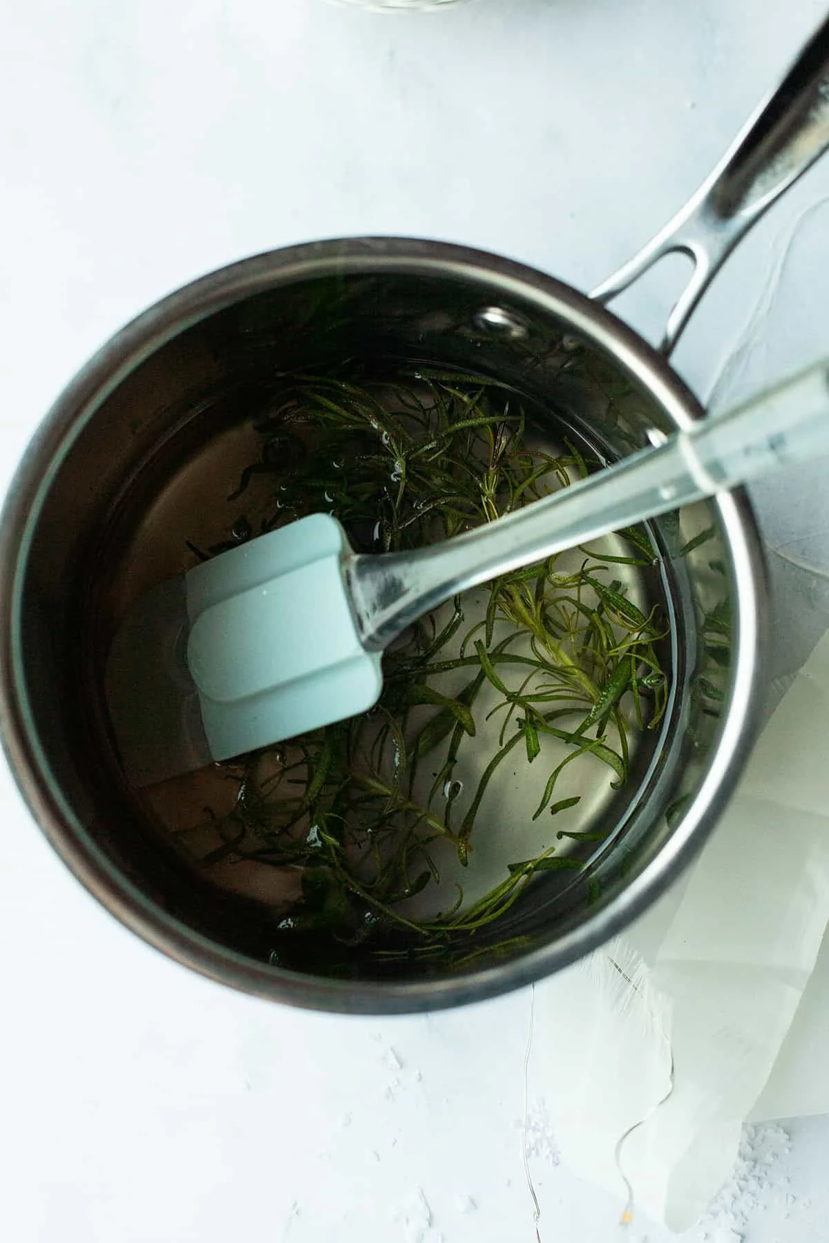 Saucepan with rosemary simple syrup.