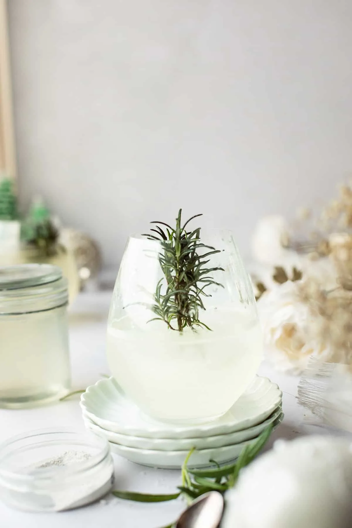 Snow globe glass with the peppermint cocktail before pouring in the sparkling element.