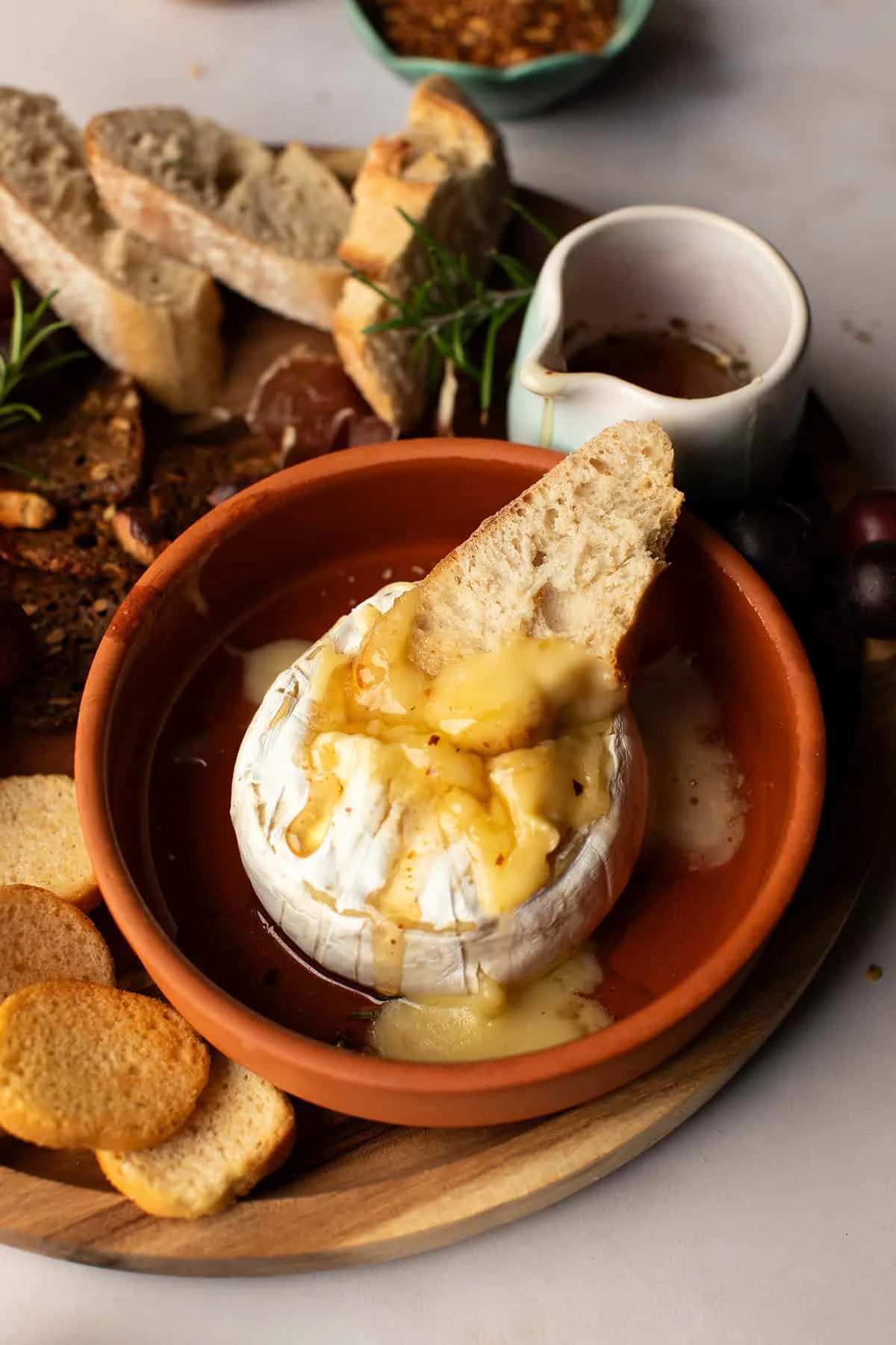 A slice of bread in a baked brie.