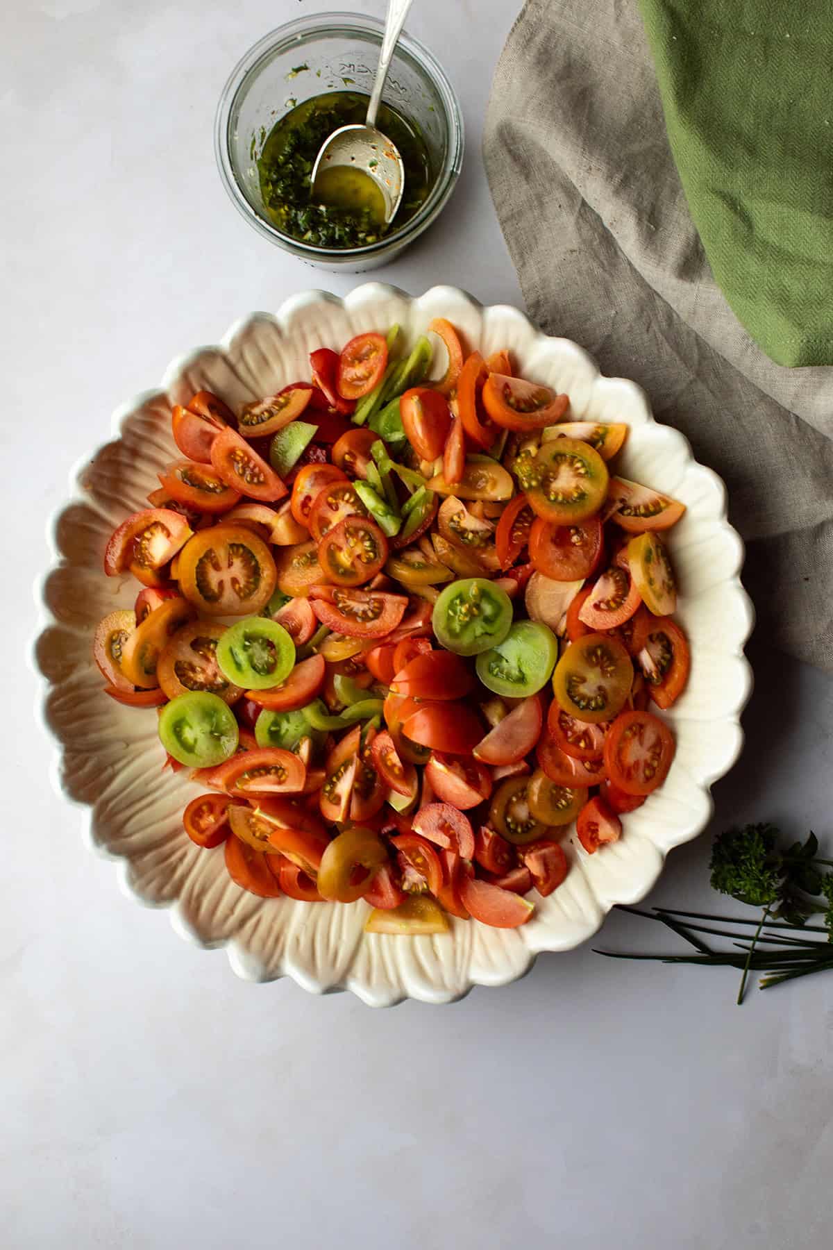 Large bowl with sliced tomatoes.
