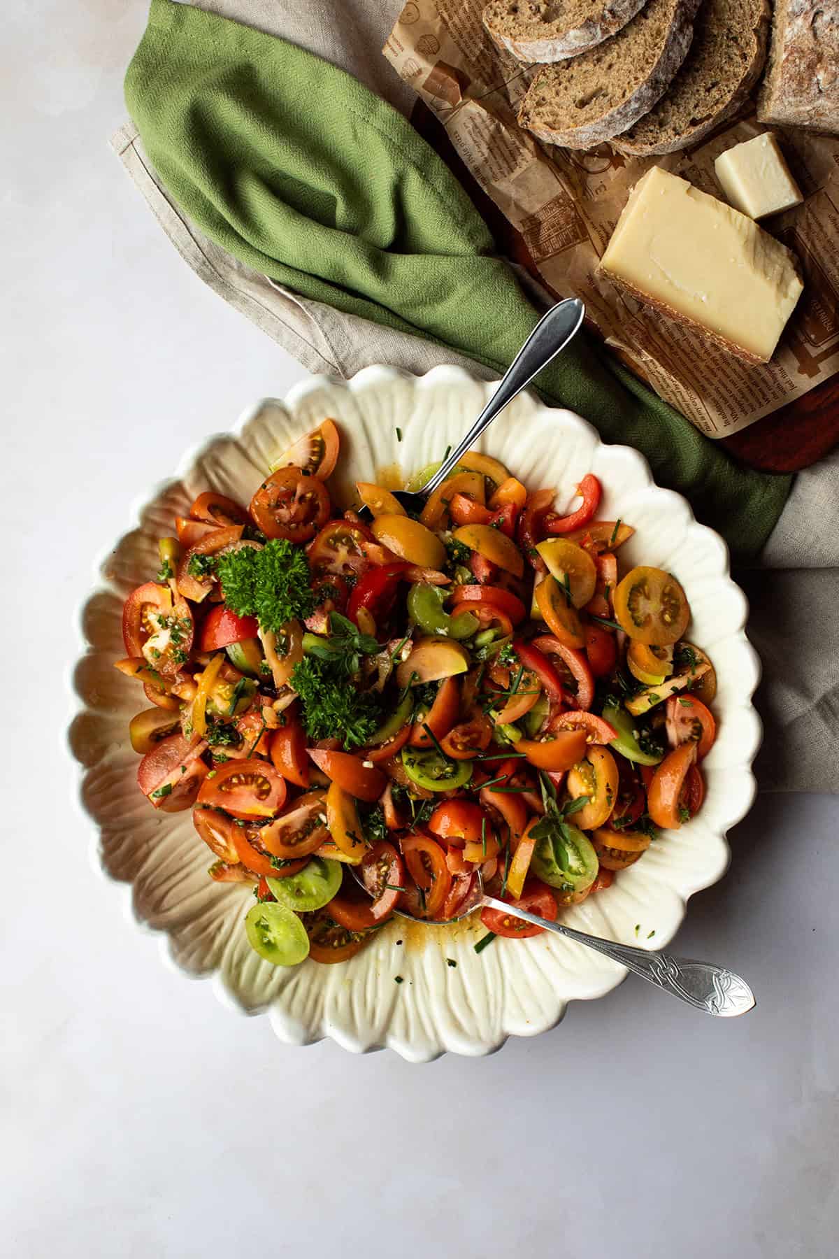 Large shallow bowl with marinated tomatoes, seen from above.