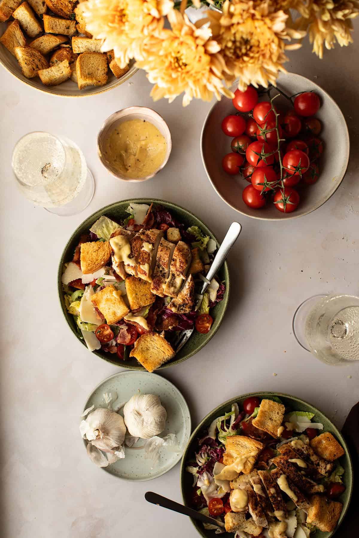 Two large bowls of chicken caesar salad seen from above.